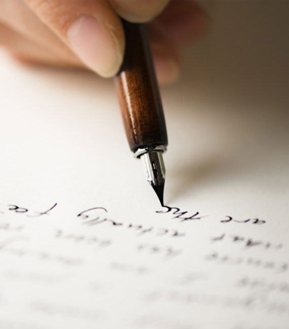 A person writing a letter with a fountain pen, showcasing the elegance of traditional writing for Script-Writing to Ebook Conversion Service.
